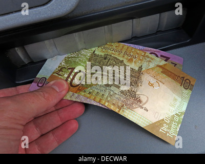 Taking Scottish sterling notes from a RBS cash machine, in Edinburgh, Midlothian, Scotland Stock Photo