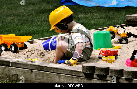 Boy plaing in sand Stock Photo