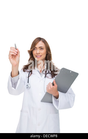 Doctor holding clipboard and pointing at something Stock Photo