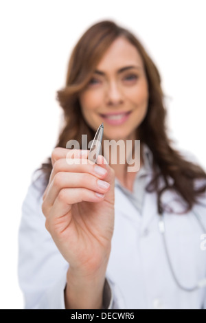 Smiling doctor holding pen Stock Photo