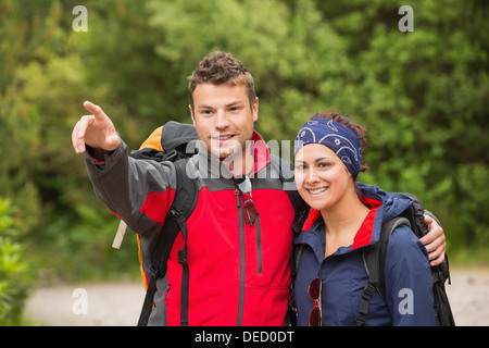 Smiling couple going on a hike together looking ahead Stock Photo