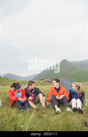 Friends talking together on a camping trip Stock Photo