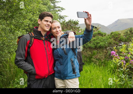 Happy couple on hike taking a selfie Stock Photo
