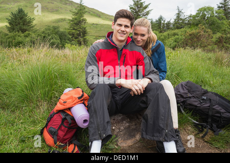Happy couple taking a break on a hike Stock Photo