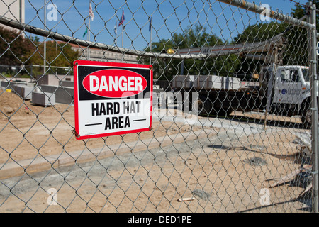 Hard hat area sign on fence Stock Photo