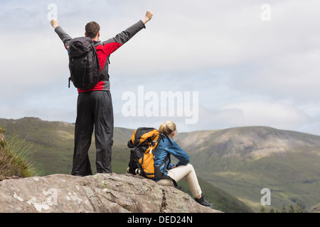 Couple reaching the top of their hike Stock Photo