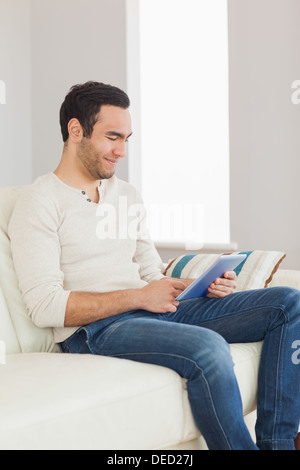 Relaxed casual man using his tablet Stock Photo