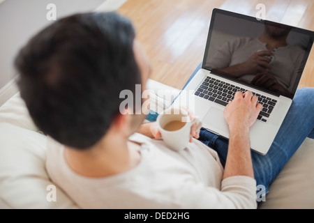High angle view of young man using his laptop Stock Photo
