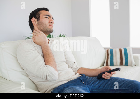 Handsome man suffering from painful neck Stock Photo