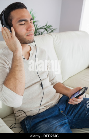 Pensive handsome man listening to music Stock Photo