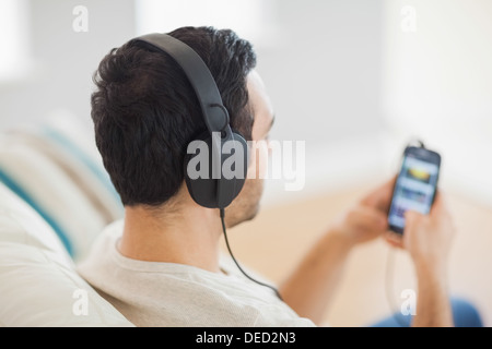 Handsome man listening to music on his smartphone Stock Photo