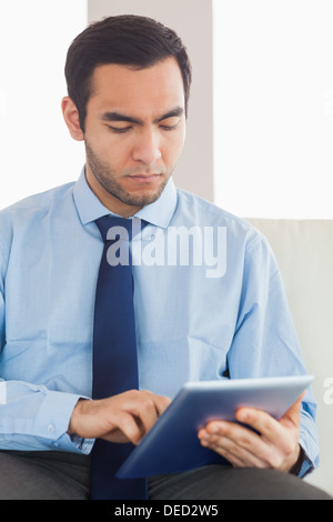 Young classy businessman using tablet pc Stock Photo