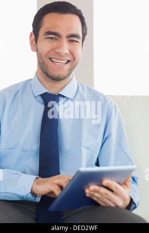Smiling classy businessman using tablet pc Stock Photo