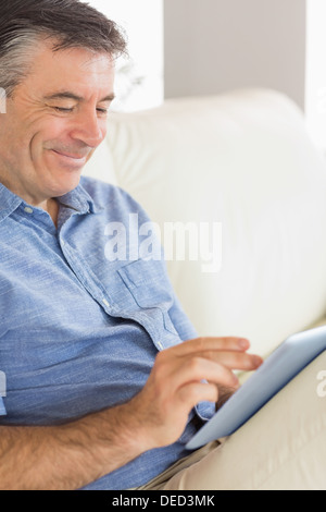 Smiling man using a tablet pc Stock Photo