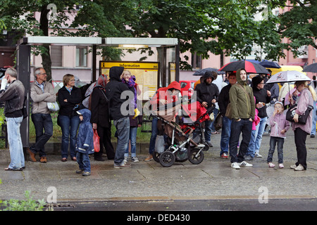 Berlin, Germany, people waiting in the rain at a bus stop for the bus Stock Photo