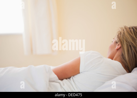 Sleeping woman on her bed Stock Photo