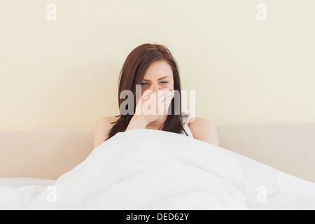 Awakened girl yawning in her bed Stock Photo