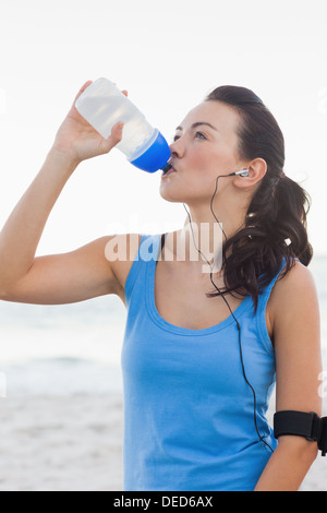 Woman drinking bottled water after doing sports Stock Photo