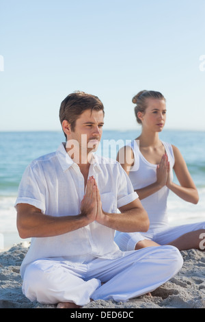 Man and woman practicing yoga Stock Photo