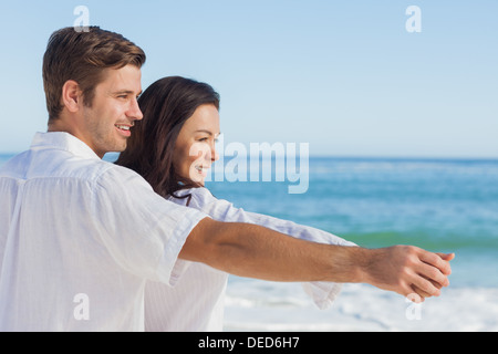 Romantic couple relaxing on the beach Stock Photo