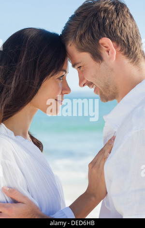 Romantic couple relaxing on the beach Stock Photo