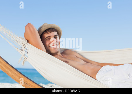 Smiling man wearing straw hat looking Stock Photo