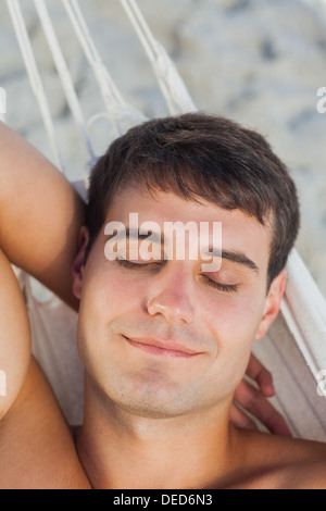 Man sleeping in hammock Stock Photo