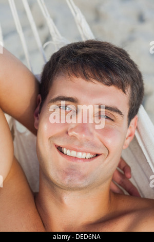 Attractive man lying in hammock Stock Photo