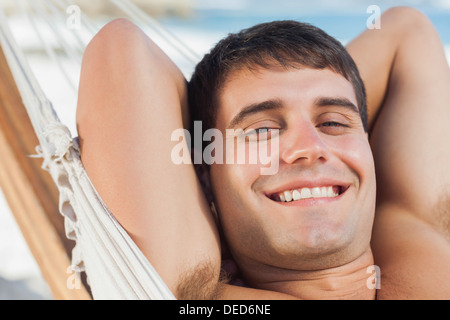 Smiling man relaxing in hammock Stock Photo
