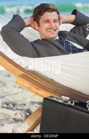 Businessman relaxing in a hammock Stock Photo