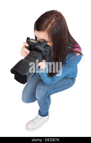 High angle view of casual young photographer taking picture Stock Photo