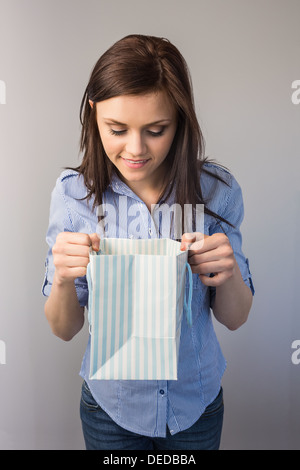 Smiling pretty brunette receiving a present Stock Photo