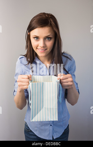 Cheerful pretty brunette receiving a present Stock Photo