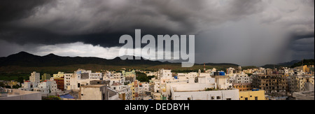 Approaching Rain clouds over the town of Puttaparthi. The birthplace of Sathya Sai Baba. Andhra Pradesh, India. Panoramic Stock Photo