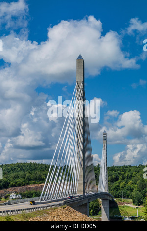 The Penobscot Narrows Bridge which includes the Penobscot Narrows Observatory with a beautiful blue sky and white puffy clouds. Stock Photo