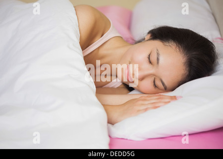 Peaceful young asian woman sleeping in her bed Stock Photo
