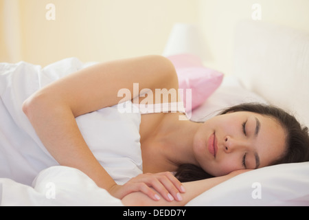Young asian woman sleeping peacefully in her bed Stock Photo