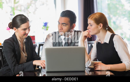 Cheerful business people working with their laptop Stock Photo