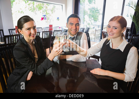 Business team celebrating a success with champagne in restaurant Stock Photo