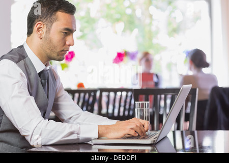 Concentrated businessman working on laptop Stock Photo