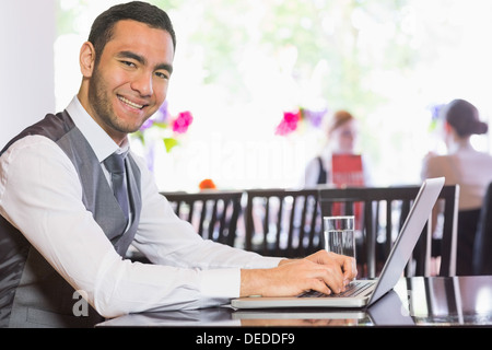 Smiling businessman working on laptop Stock Photo