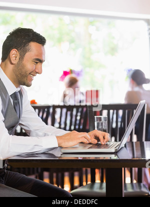 Smiling businessman looking at laptop screen Stock Photo