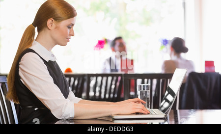 Concentrated businesswoman working on laptop Stock Photo