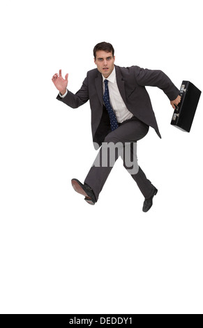 Focused businessman holding a briefcase and running Stock Photo