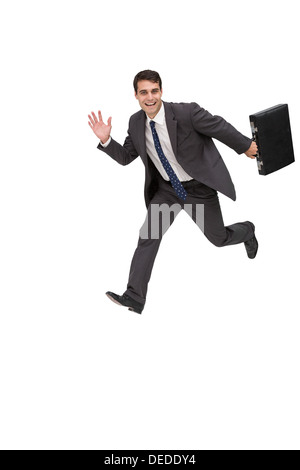 Happy businessman holding a briefcase and running Stock Photo