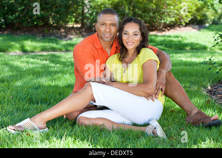 A young African American woman & man couple outside in the summer Stock Photo