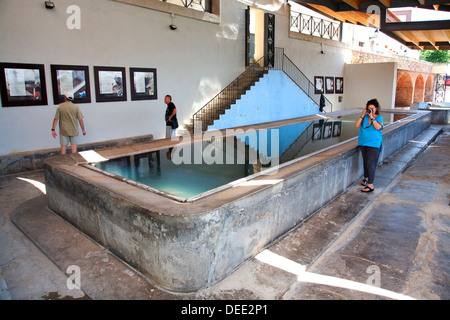 Visitors at thermal bath used for washing clothes, Caldes de Montbui, Barcelona, Spain. Stock Photo