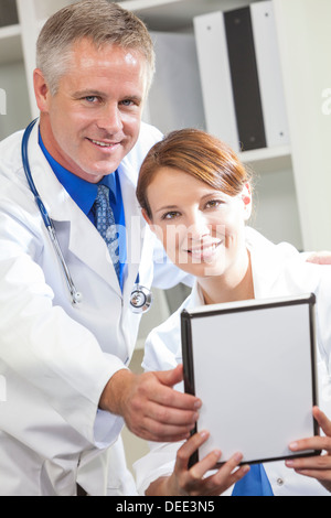 Male & female medical doctors using a tablet computer in a hospital Stock Photo