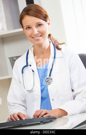 Woman female medical doctor using computer in her hospital office Stock Photo