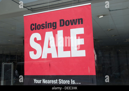 closing down sale sign in the window of an empty shop Stock Photo
